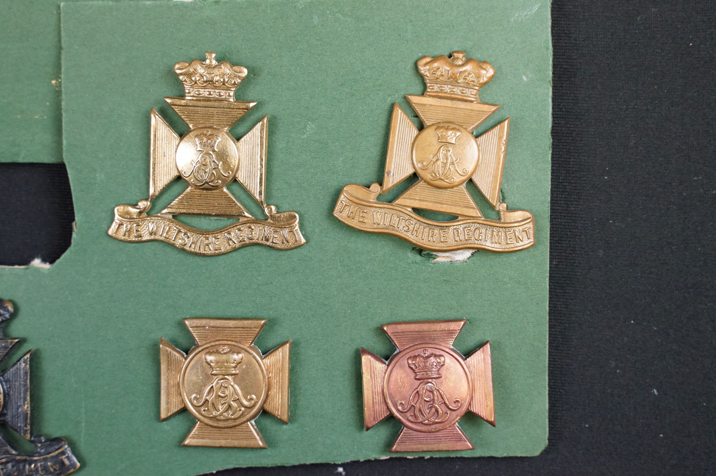 A collection of The Wiltshire Regiment cap and collar badges. - Image 3 of 5