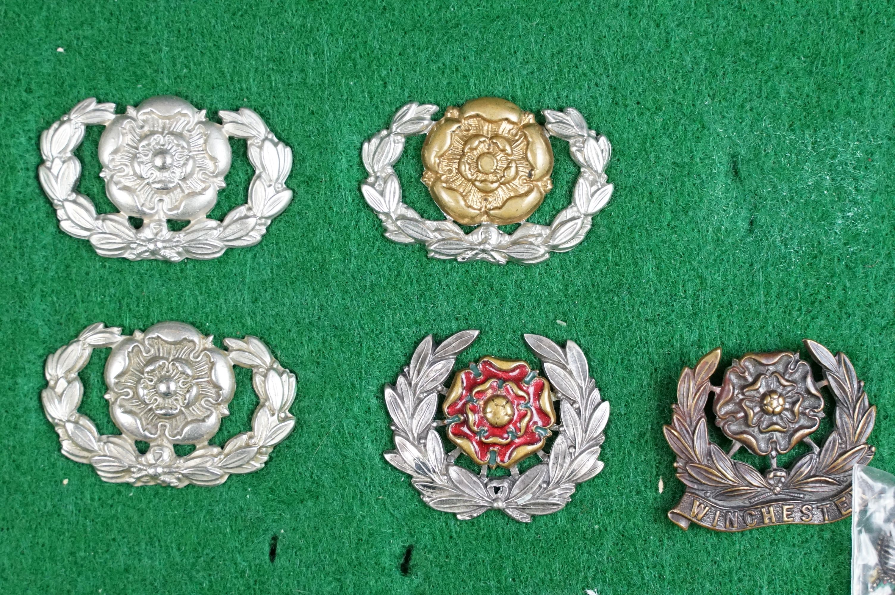 A collection of British The Hampshire Regiment cap badges, collar badges and shoulder titles to - Image 2 of 9