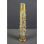 A trench art vase with ornate decorative design made from a spent artillery shell.