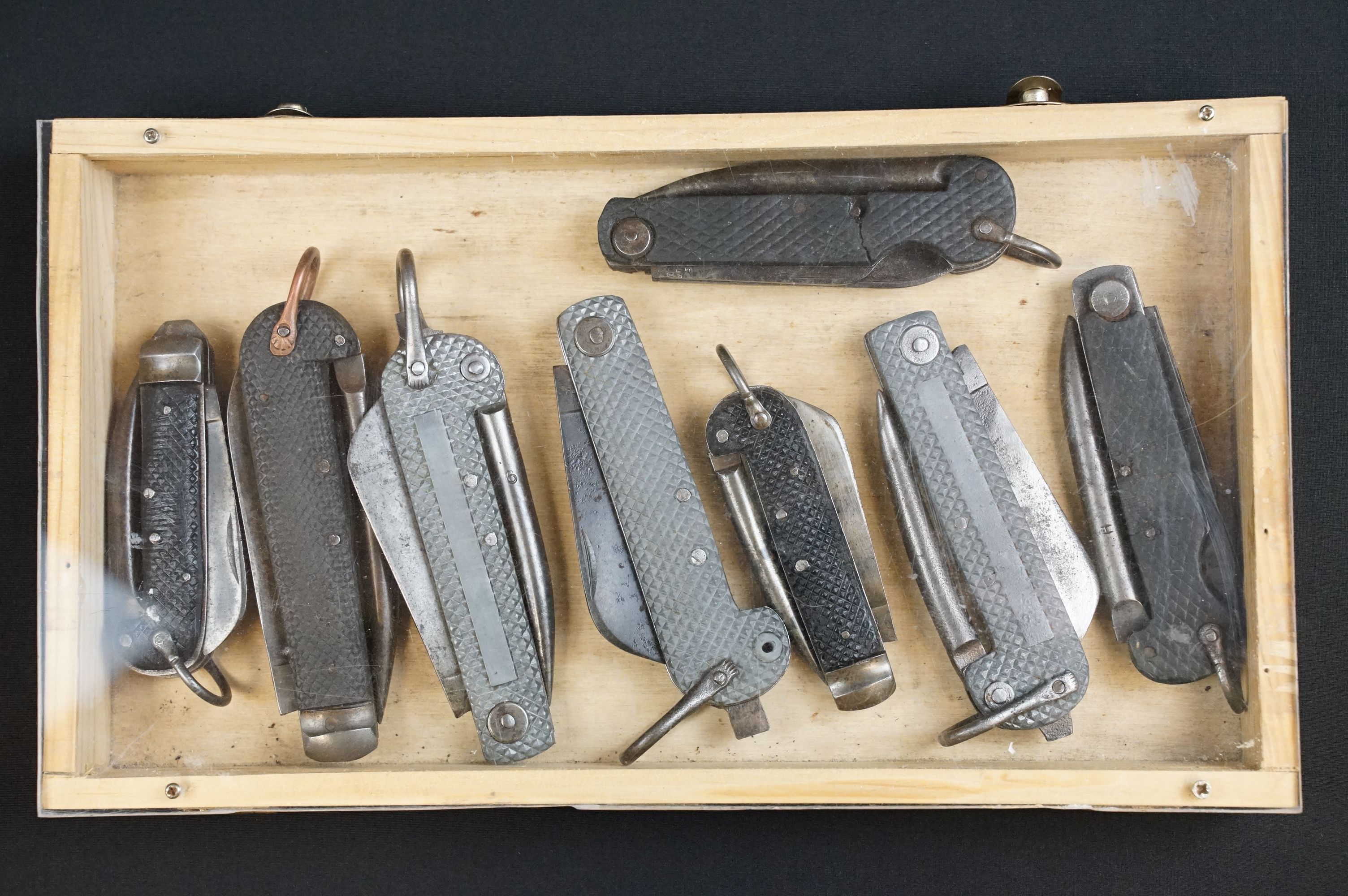 A collection of eight British military issued jack knives to include Army and Navy examples,