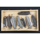 A collection of eight British military issued jack knives to include Army and Navy examples,