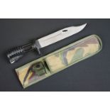 A Contemporary socket mount bayonet housed within canvas camouflage sheath.