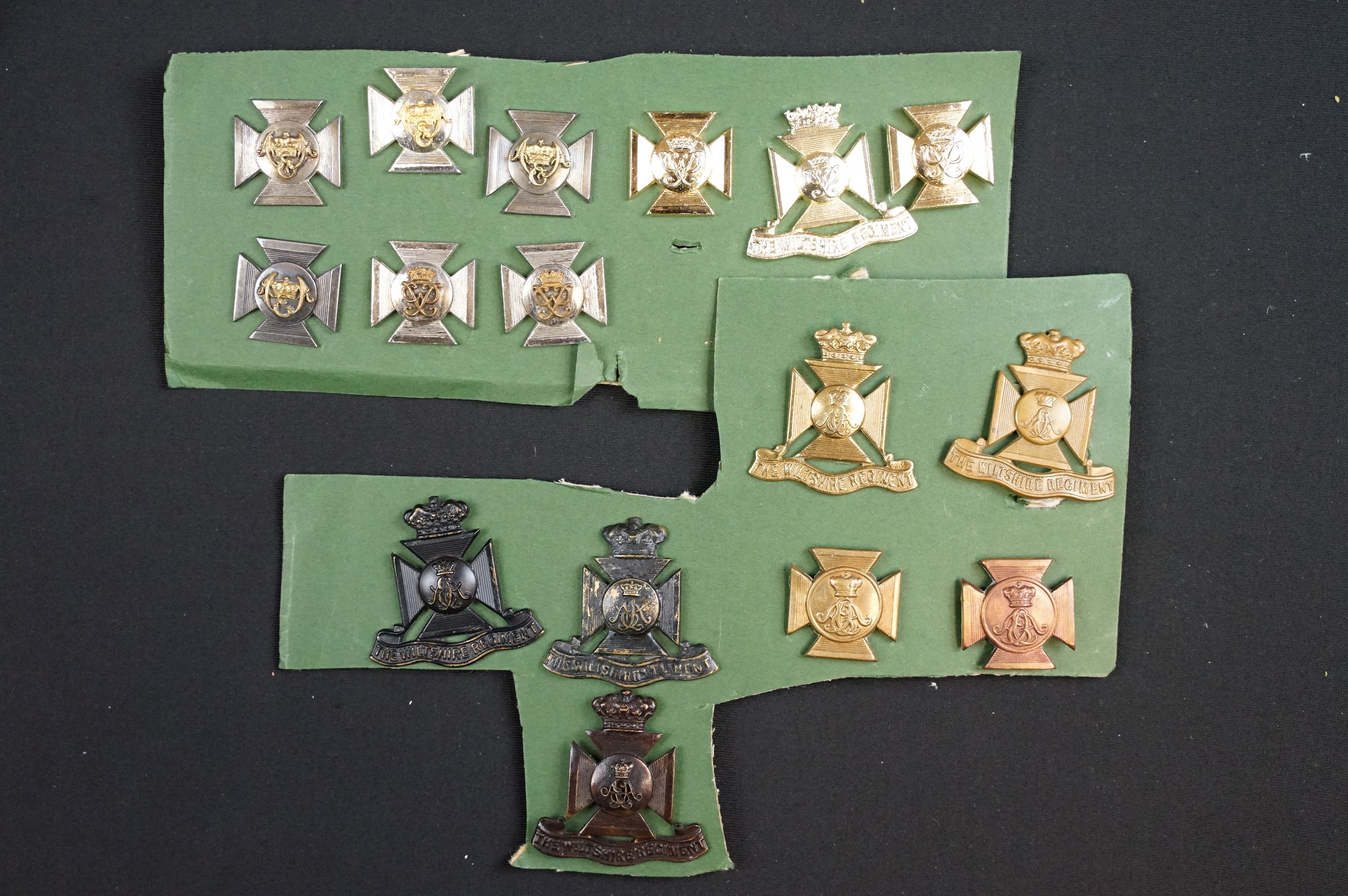 A collection of The Wiltshire Regiment cap and collar badges.