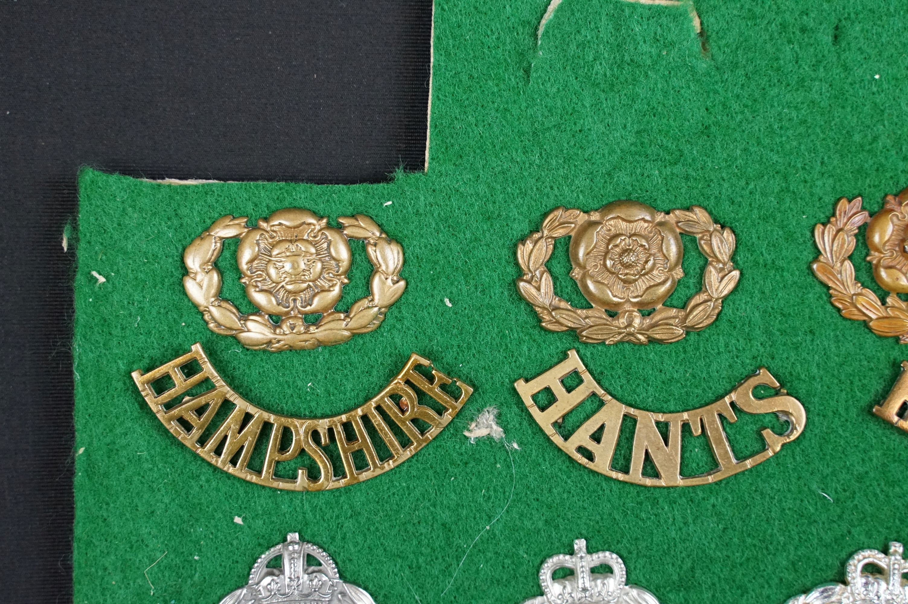 A collection of British The Hampshire Regiment cap badges, collar badges and shoulder titles to - Image 7 of 9