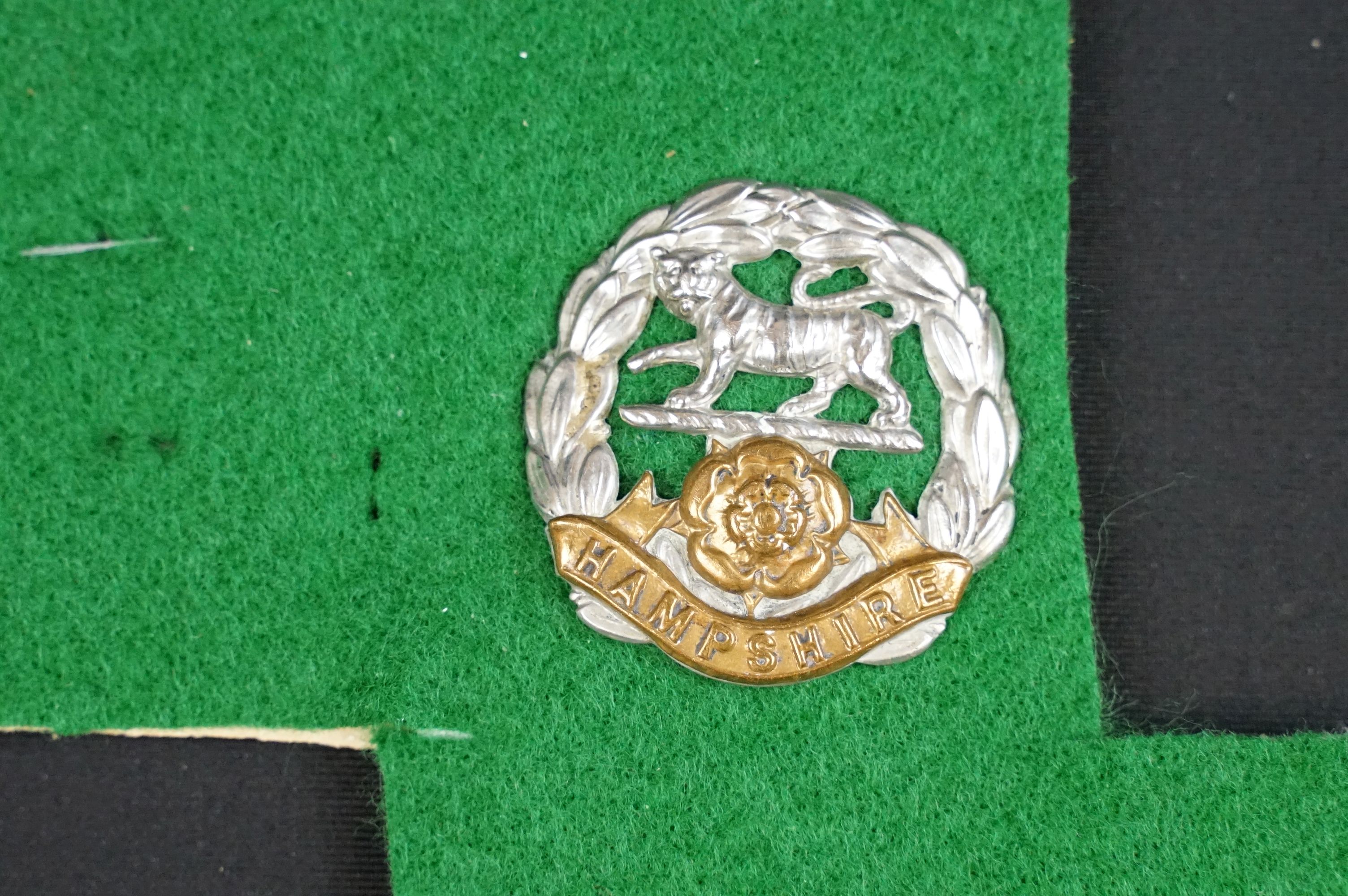 A collection of British The Hampshire Regiment cap badges, collar badges and shoulder titles to - Image 5 of 9