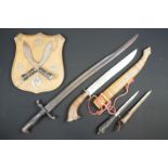 A small group of knives to include a military bayonet, two Arabic daggers and a pair of mounted