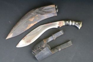 A vintage military supply syndicate Nepalese kukri with leather case. Together with both small