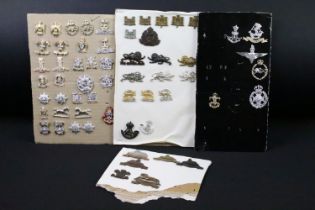 A collection of British military regimental cap and collar badges to include the Lincolnshire