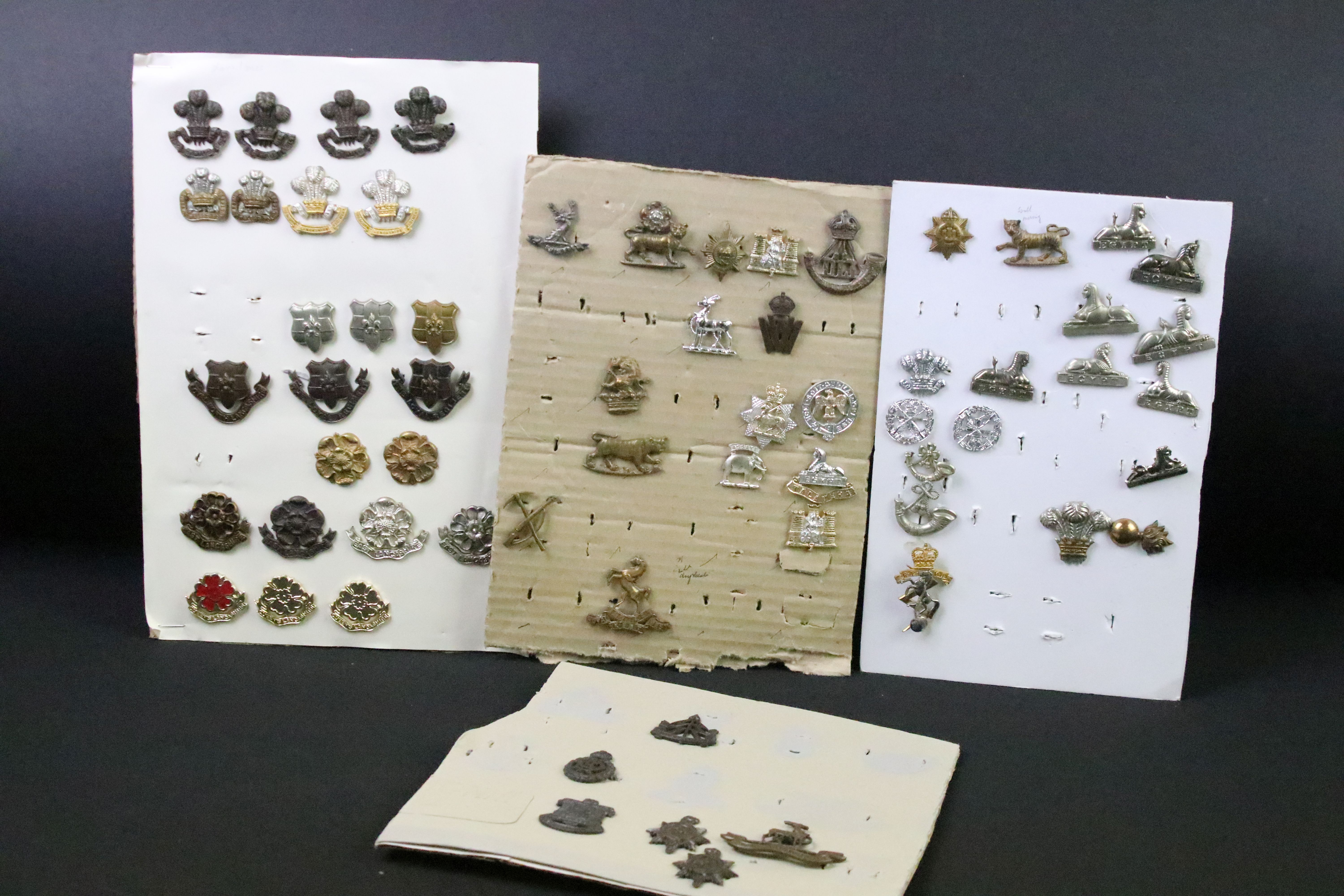 A collection of British military Regimental cap and collar badges to include the East Lancashire