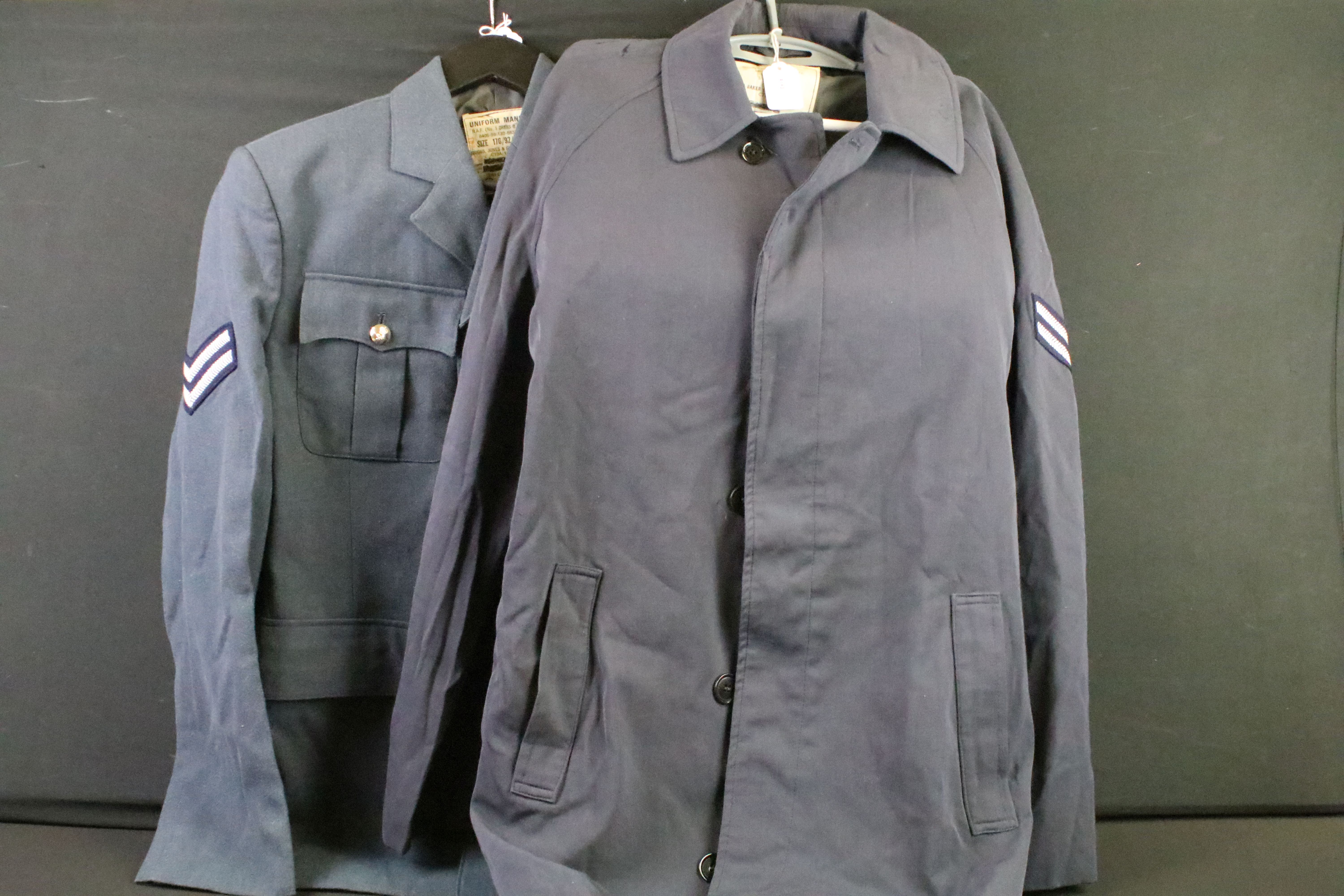 A selection of British Royal Air Force / RAF uniform to include two jackets and an overcoat.