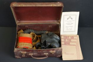 A Vintage World War Two British issued respirator together with associated Civil Defence paperwork.