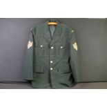 A Canadian military jacket complete with gilt buttons and cloth patches.