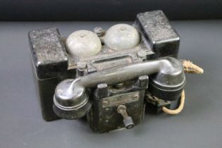 A British World War Two wind up field telephone, bakelite housing stamped with the British broad