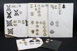 A collection of British military regimental cap and collar badges to include the Royal Scots