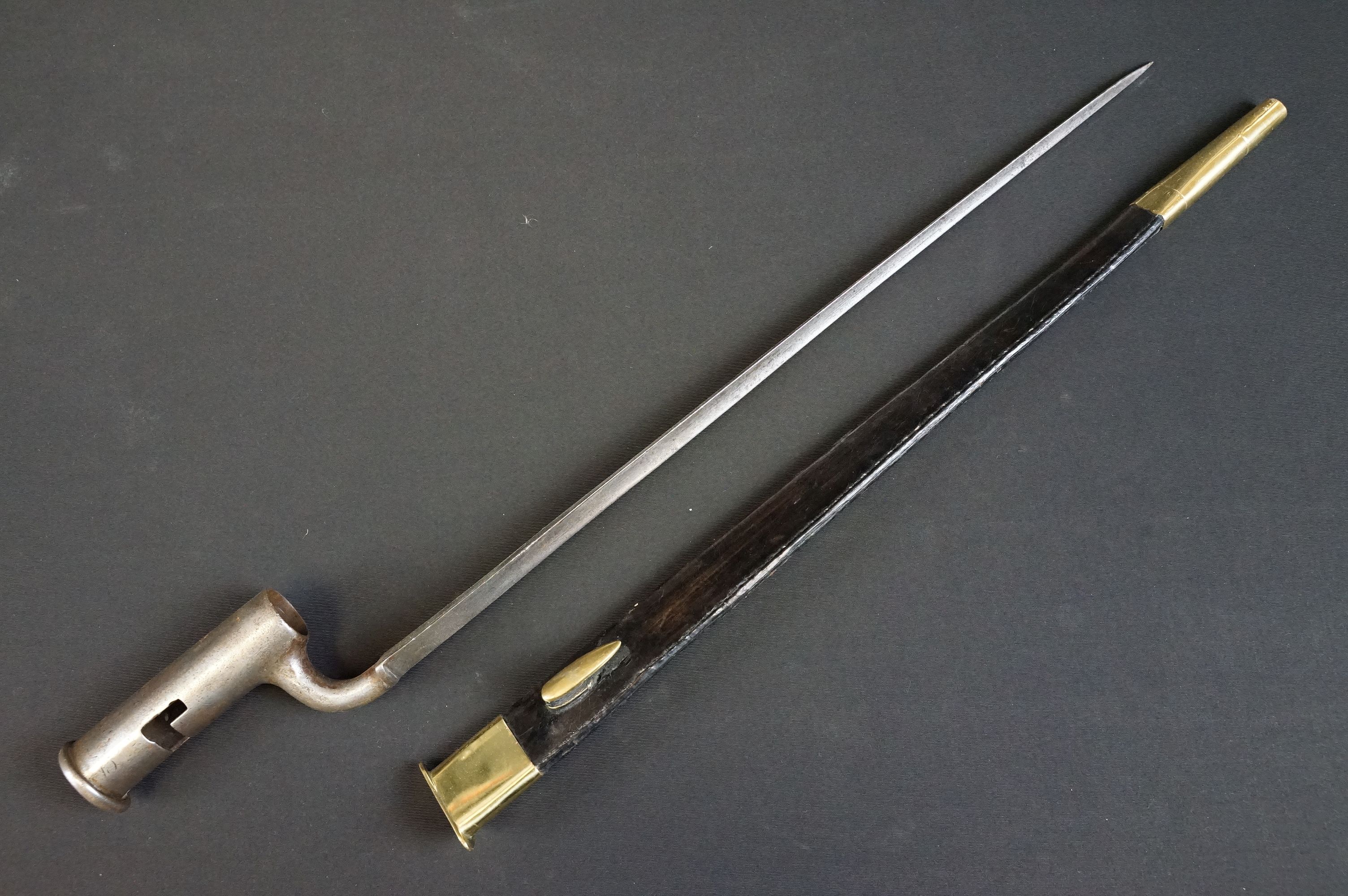 A 1858 pattern brown bess rifle bayonet together with leather scabbard.