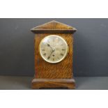 A World War Two wooden cased chiming mantle clock, the face etched with the badge of the RAF / Royal