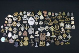 A large collection of mainly British and Commonwealth cap and collar badges to include King Crown