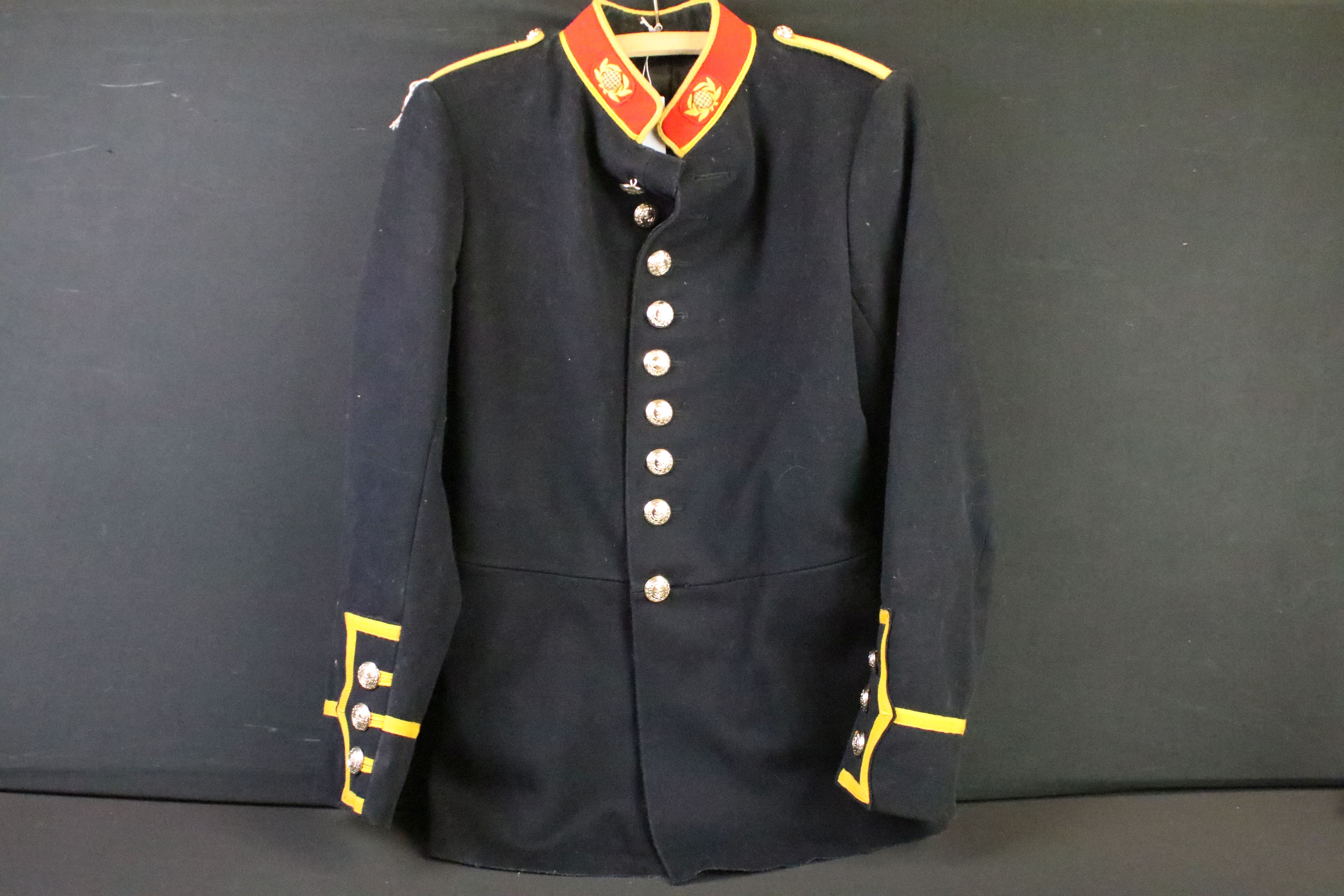 A British Royal Marines dress jacket complete with cloth collar badges and staybrite buttons.