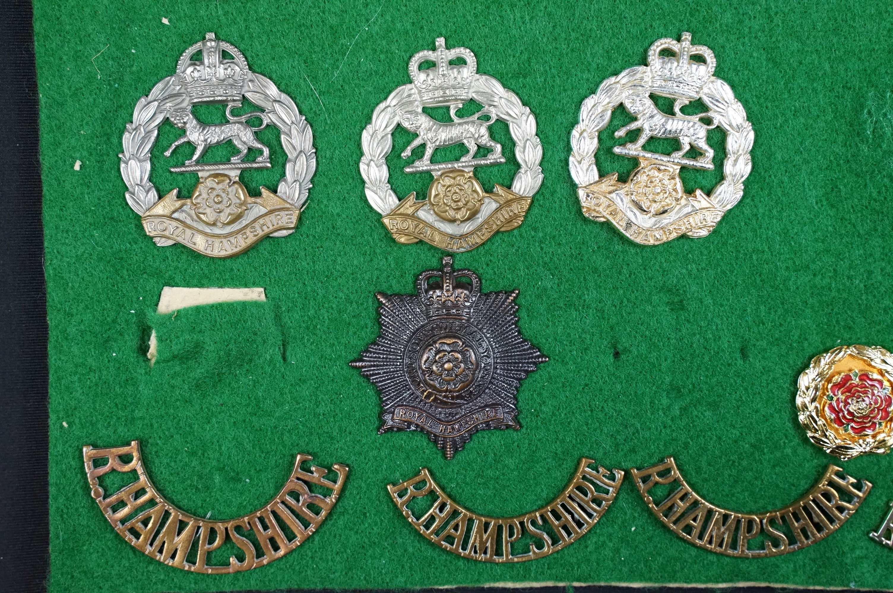 A collection of British The Hampshire Regiment cap badges, collar badges and shoulder titles to - Image 8 of 9