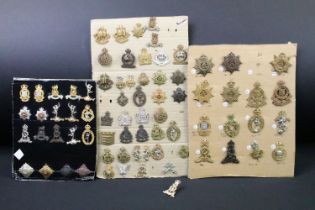 A collection of British military regimental cap and collar badges to include the Army Service Corps,