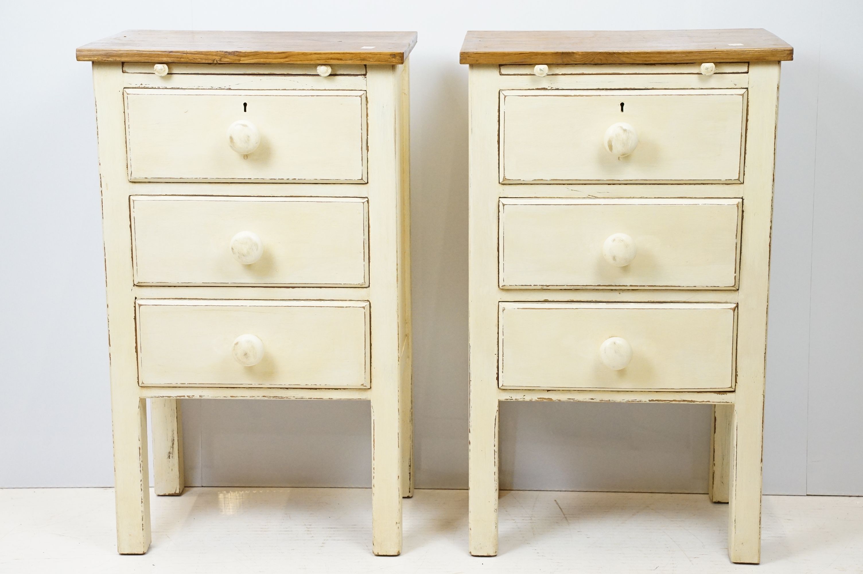 Pair of vintage painted bedside chests, each with three drawers and brushing slide, 76cm high 45.5cm