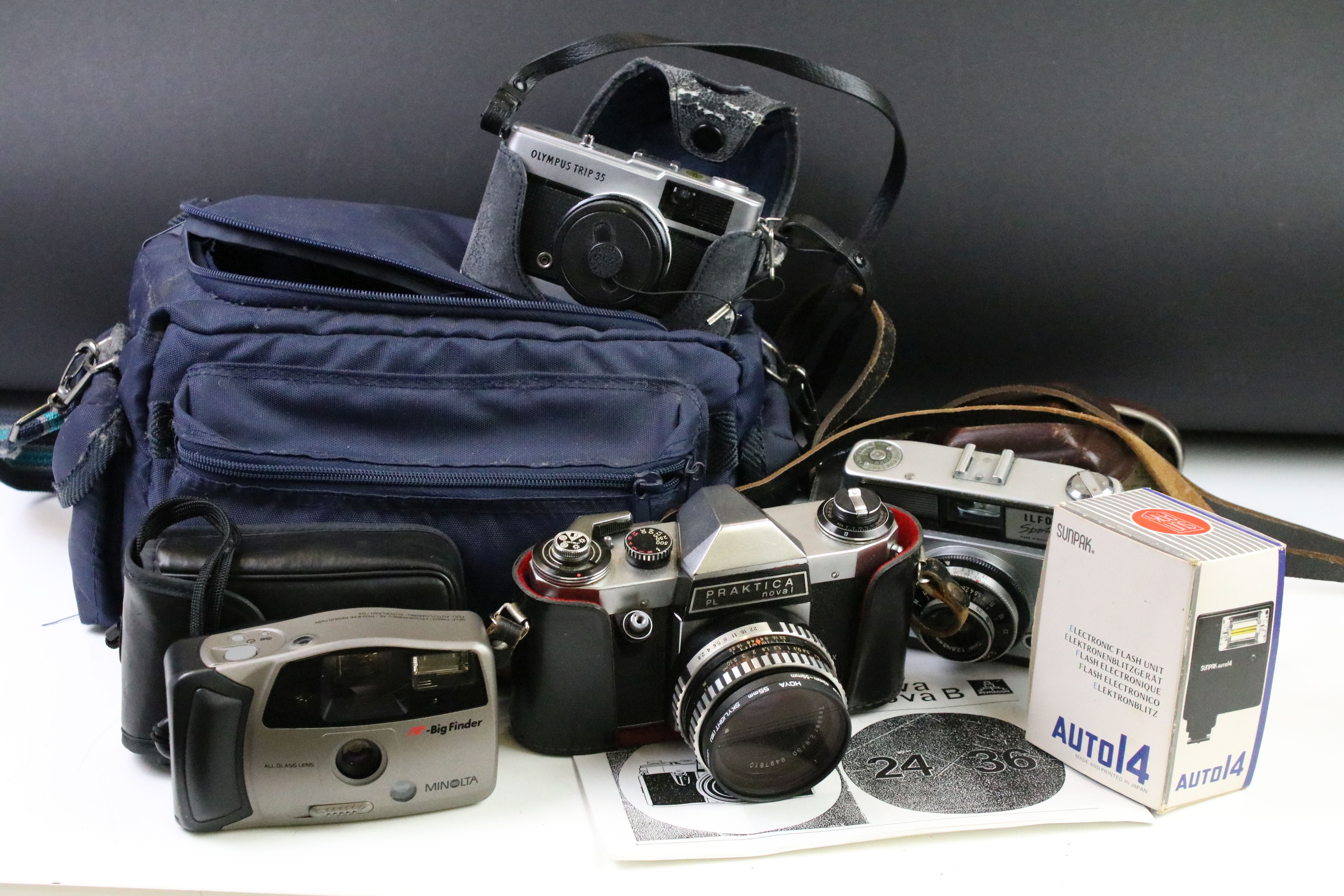 Group of cameras to include an Olympus trip 35 film camera with tripod and camera bag, Praktica PL