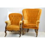 Early 20th century wing back armchair of curved form, with button back, upholstered in orange, on