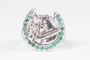 Silver horse shoe ring set with emeralds