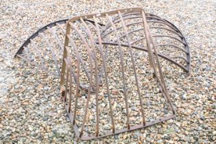 Pair of cast iron hay baskets together with another similar.