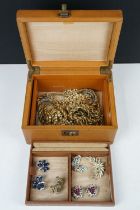 A small collection of vintage costume jewellery within a vintage jewellery box.