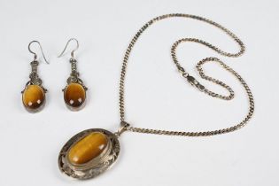 Silver and tiger's eye pendant, on silver chain, together with a pair of silver and tiger's eye drop