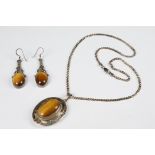 Silver and tiger's eye pendant, on silver chain, together with a pair of silver and tiger's eye drop