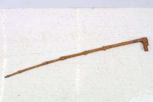 Late 19th / early 20th century Fruitwood Walking Stick, the handle carved in the form of a dog’s /