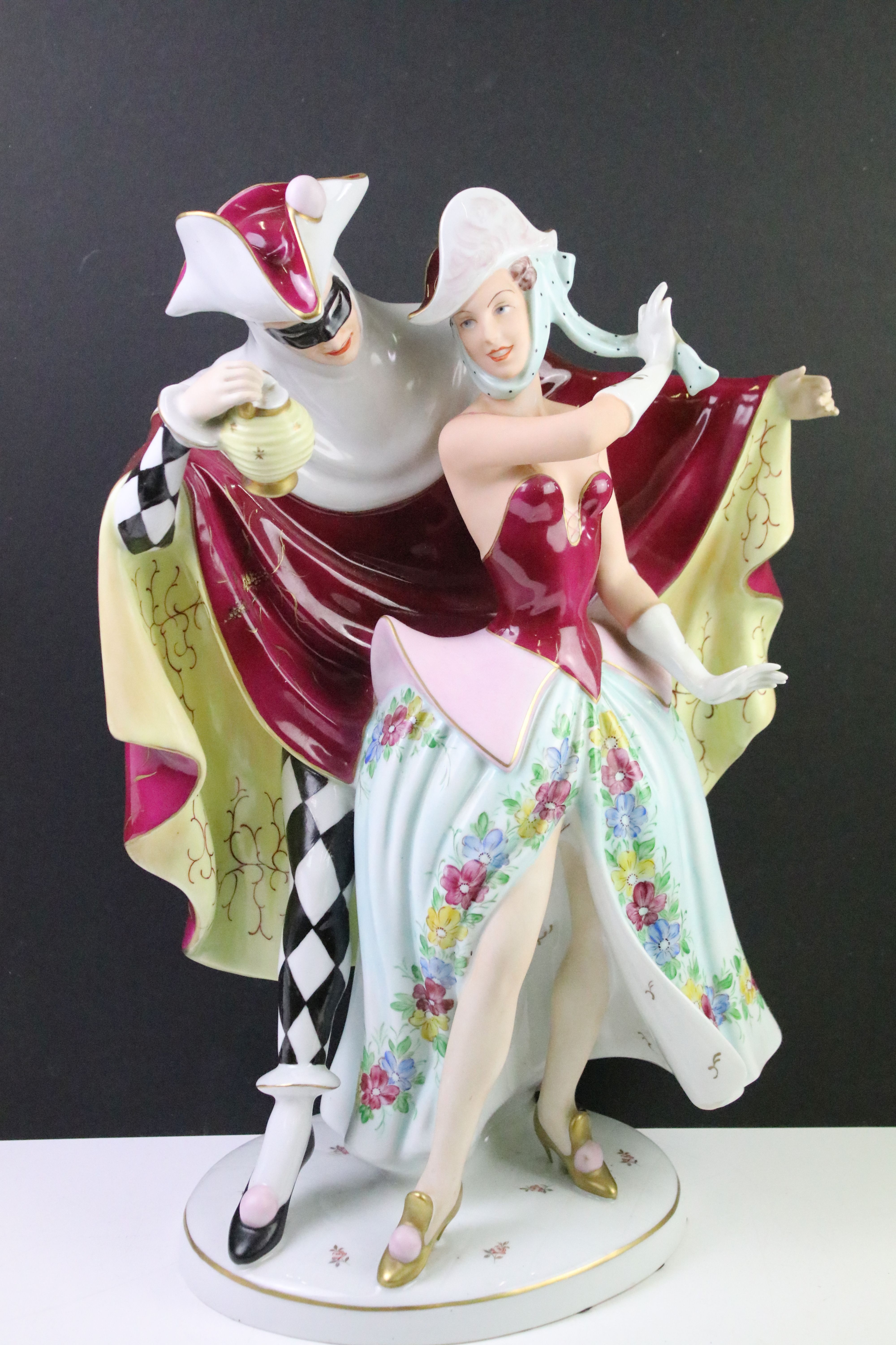 Mid 20th Century Royal Dux carnival figure group depicting a couple dressed for carnival with hand