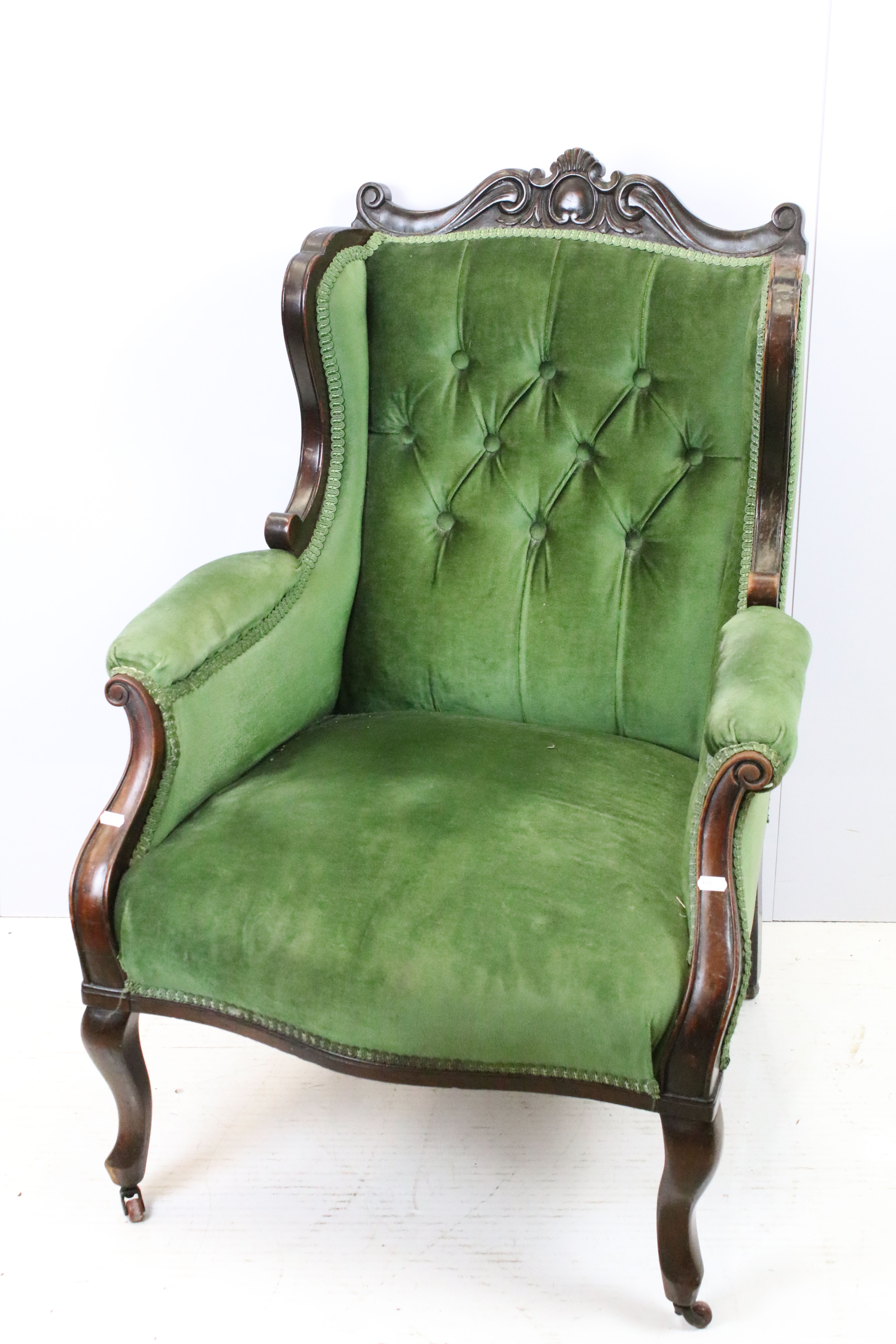 Victorian mahogany armchair, with carved top rail, upholstered in green with button back, on