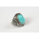 A 925 sterling silver ring set with turquoise cabochon, decorative shoulders, marked 925 for