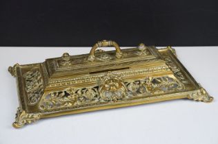 Cast brass inkstand with ornate scrolling and lion mask detail, with hinged cover, approx 35cm wide