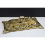 Cast brass inkstand with ornate scrolling and lion mask detail, with hinged cover, approx 35cm wide