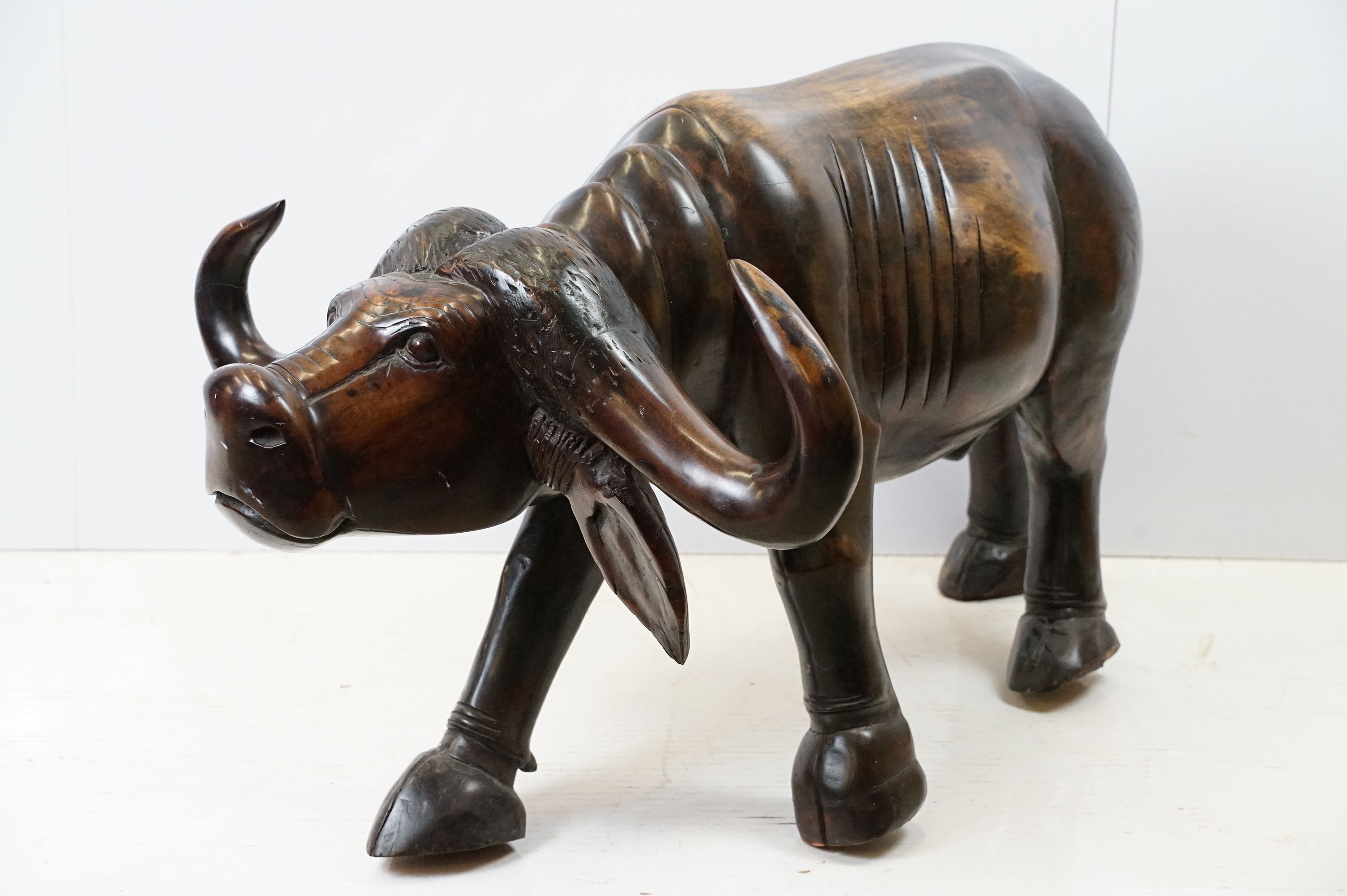 Hardwood carved figure of a water buffalo, 57cm high x 109cm long x 33cm deep