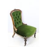 Edwardian nursing chair, with carved back, upholstered in green with button back, on turned legs and