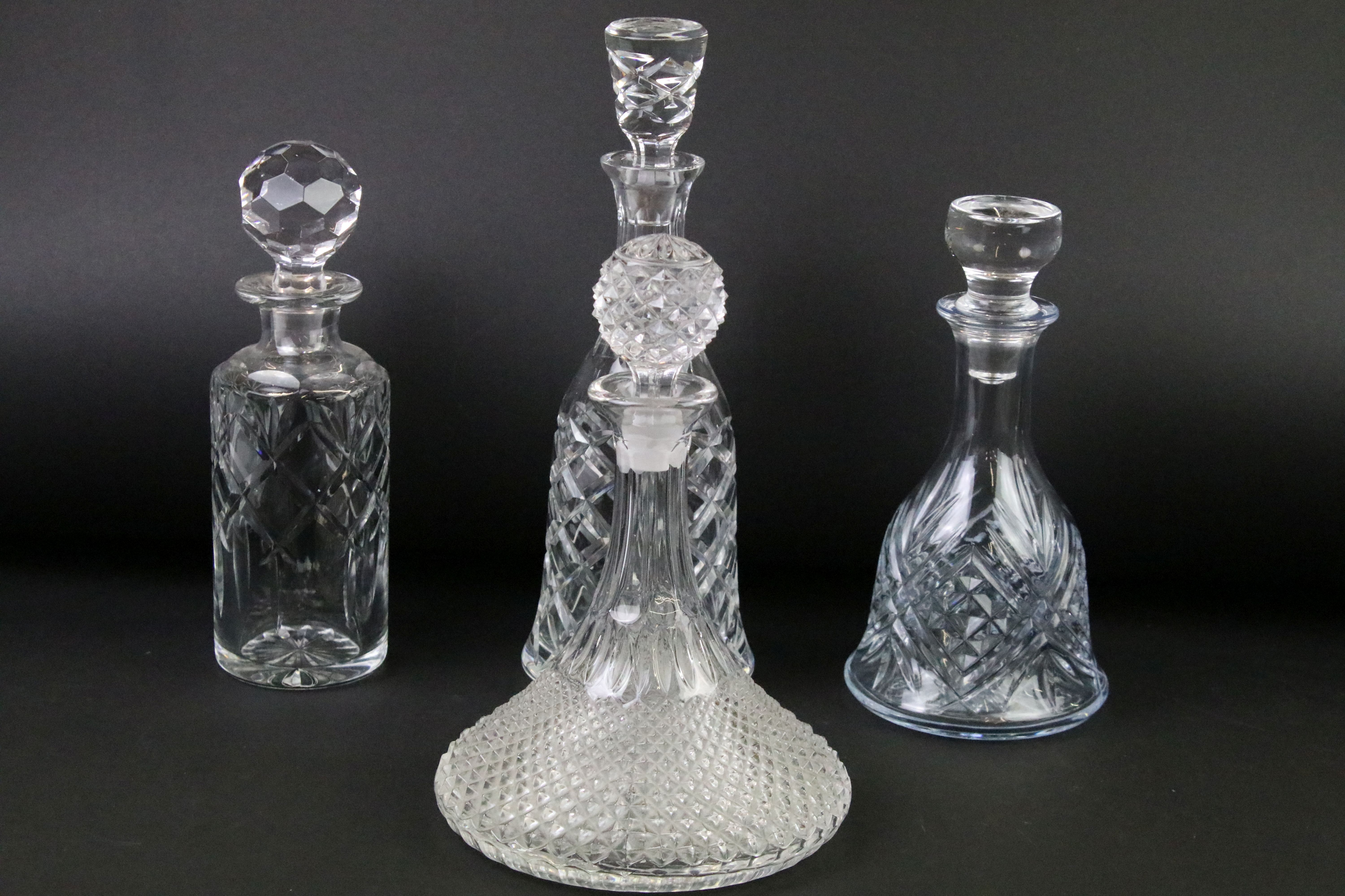 Four moulded / cut glass decanters to include a hobnail effect ships decanter, bell-shaped decanter,