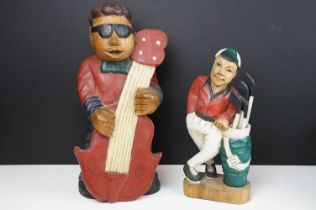 Two carved wooden figures to include a double bass band player and golfer. Tallest measures 41cm