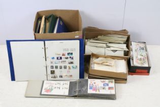 Three boxes of loose world stamps, together with a selection of albums housing mostly late 20th