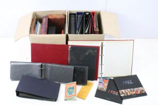 Two boxes of assorted empty stamp albums.