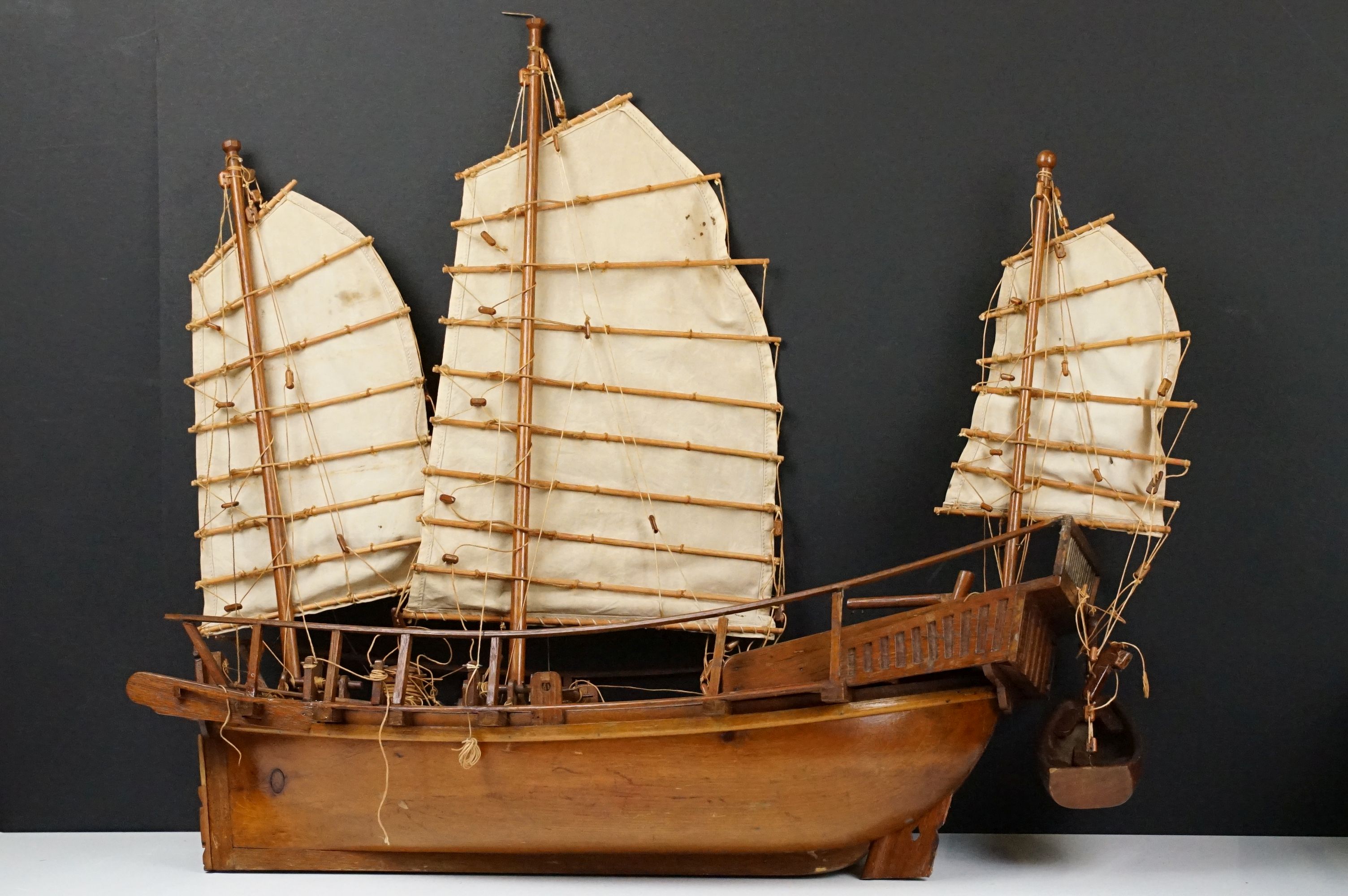 20th Century scratch built junk ship model having three sails, rope detailing, and life boat.