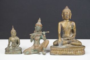 Two bronze seated Buddhas and a statue of a seated Thai prince playing a flute (possibly Prince Phra