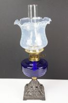 Early-to-mid 20th C oil lamp with opalescent flared glass shade, chimney, cobalt blue glass font and