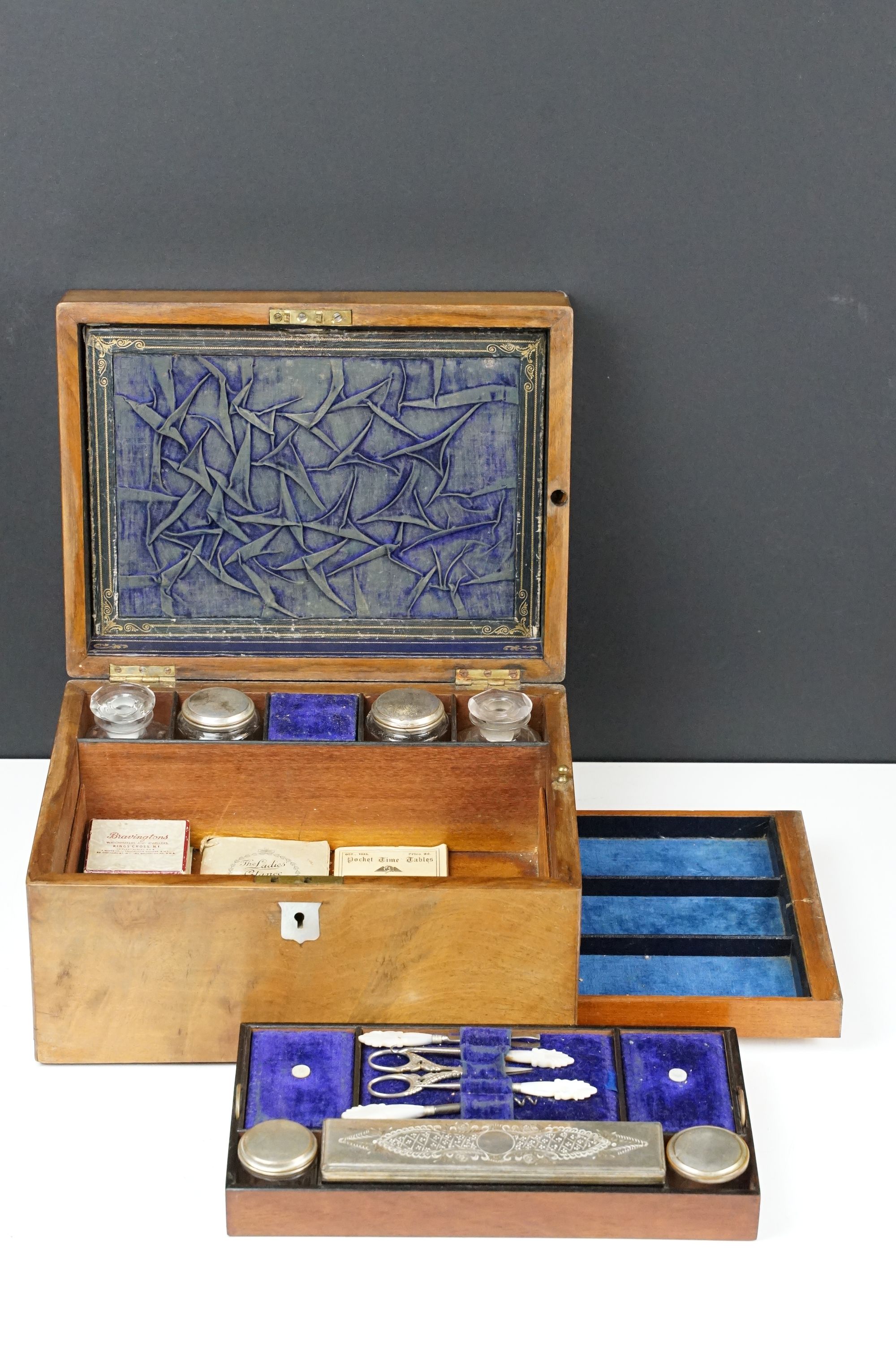 19th century walnut vanity box, the lid with mother of pearl inlay, opening to a fitted interior