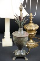 Group of three 20th Century lamp bases to include an aged metal pineapple lamp base raised on paw