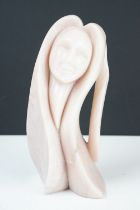 Carved pink stone sculpture of a stylised female, engraved 'Morning Rise' and signed to base, approx